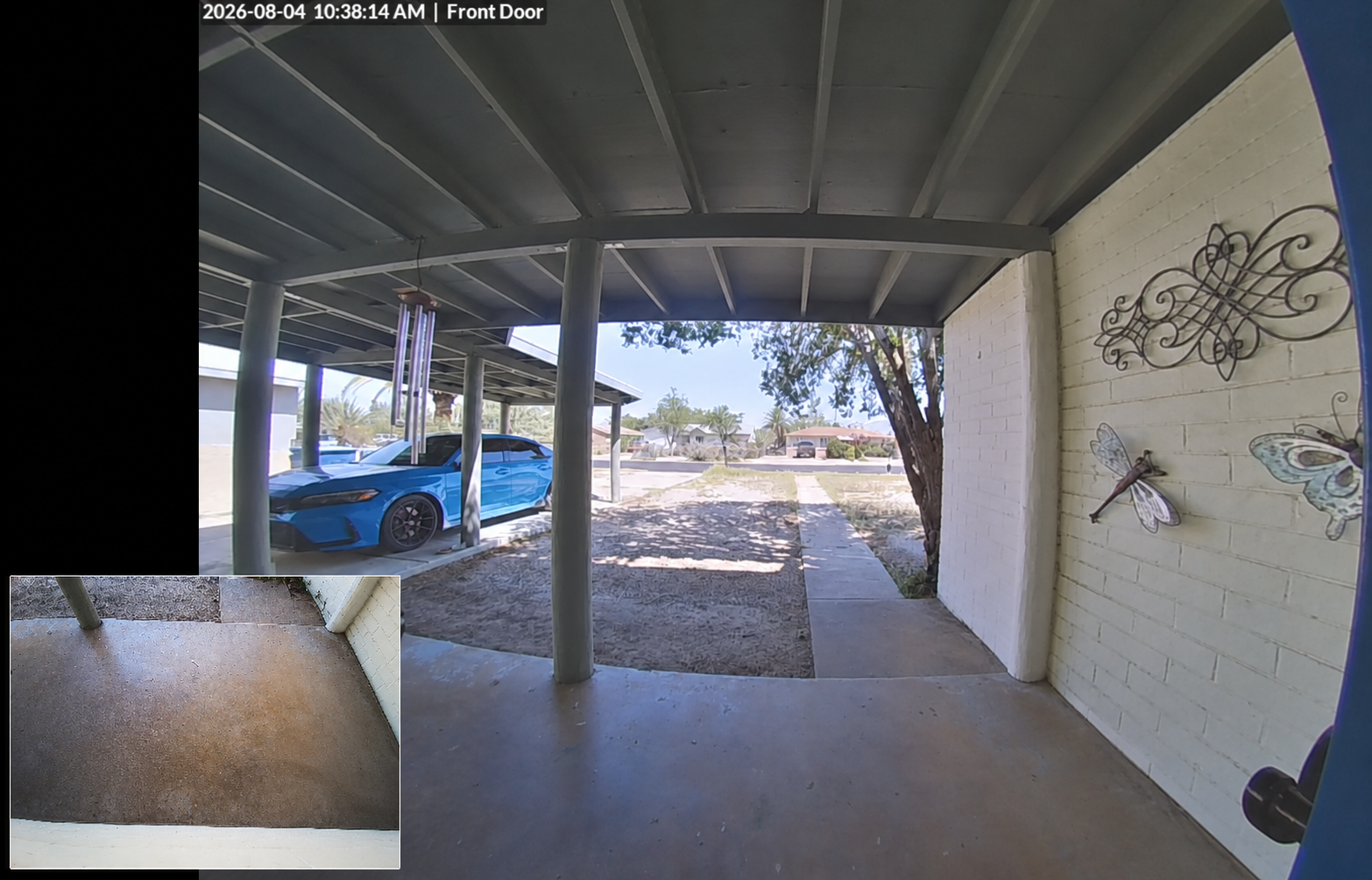 UniFi doorbell camera view of a Tucson front entry with a blue car