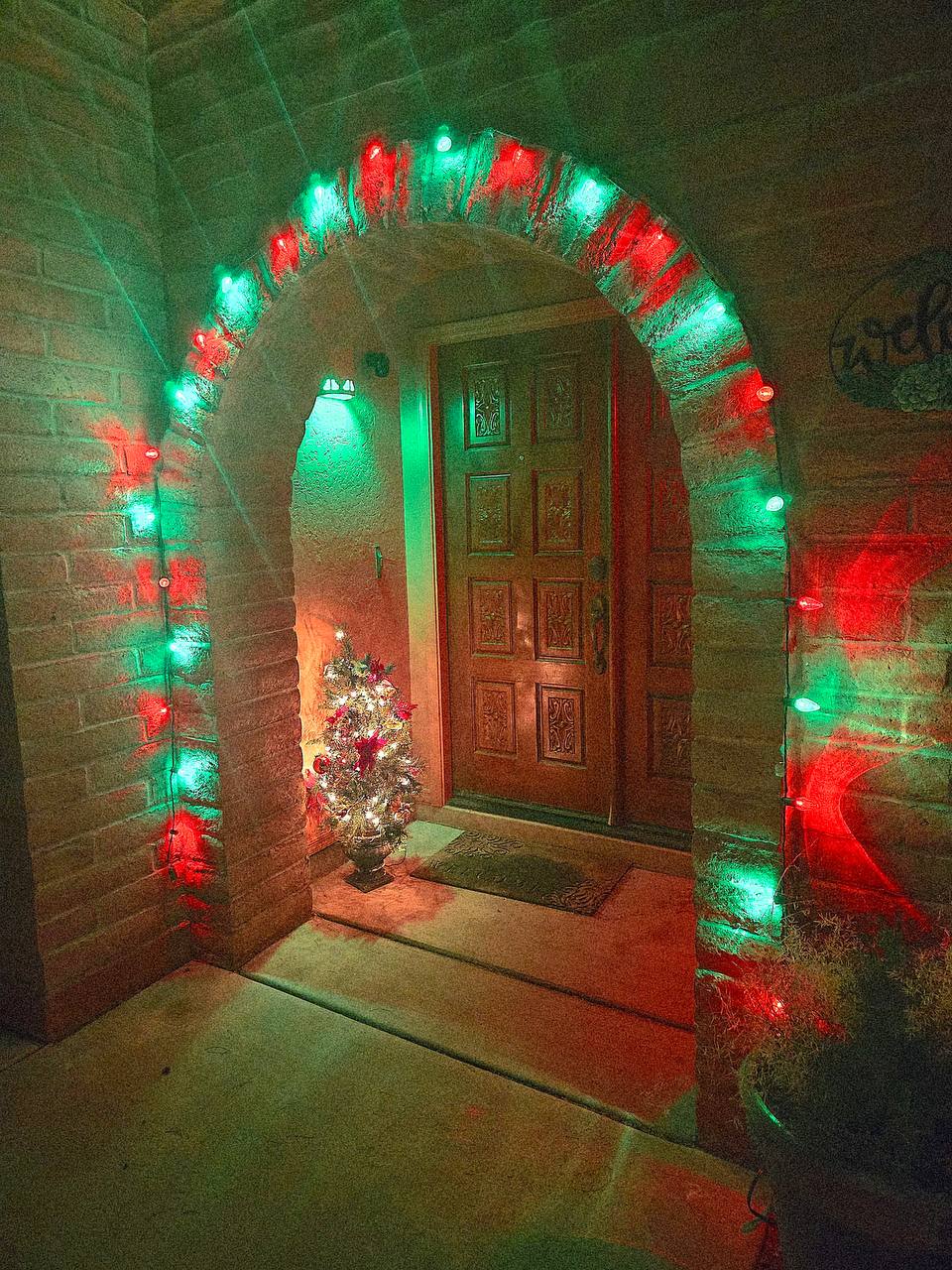 Holiday lights installed around a Tucson front entry