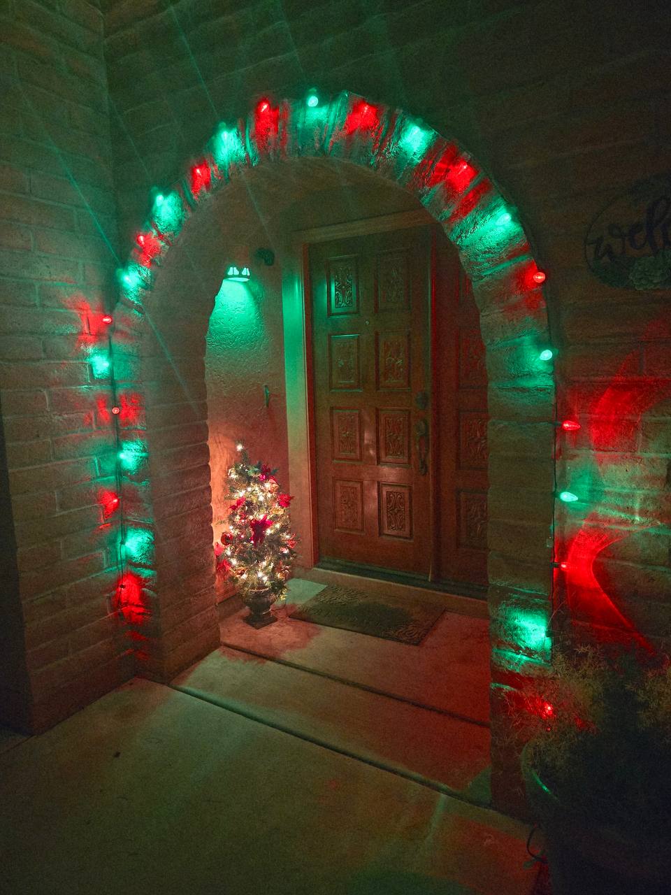Holiday lights installed around a Tucson front entryway
