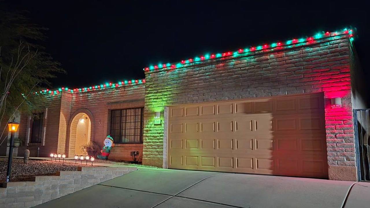 Holiday lights installed along a Tucson home roofline