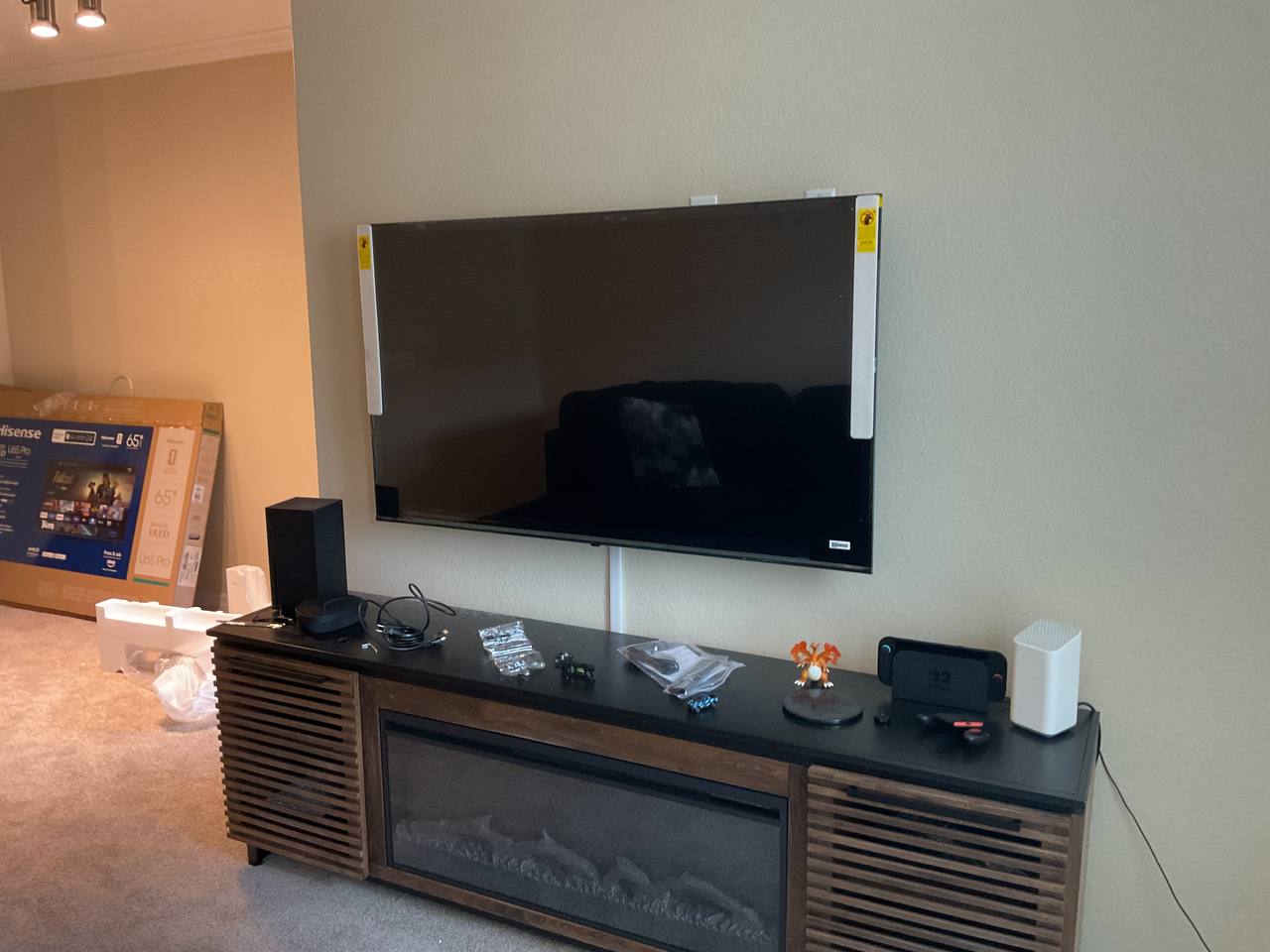 Large television mounted above a media console in a Tucson home